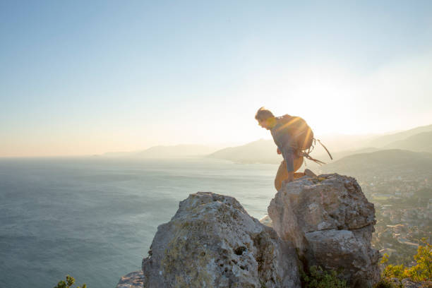 istock Man hikes along mountain ridge at sunrise 1285787940