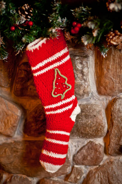 istock Christmas red knitted stock on fireplace background 1285788623