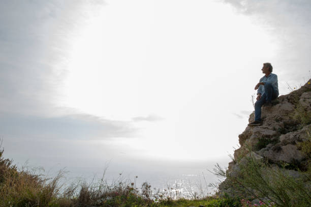 istock Hiker relaxes on coastal ridge in the morning 1285789231