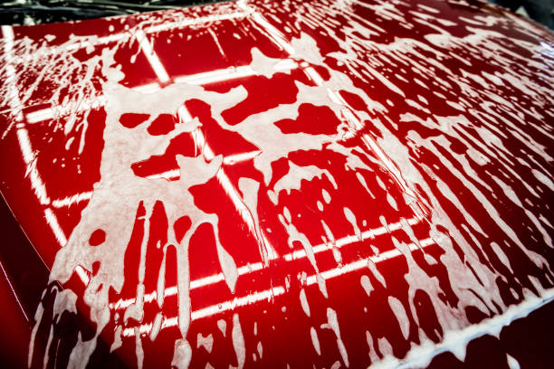 istock Washing red car with active foam at car wash service. 1285789306