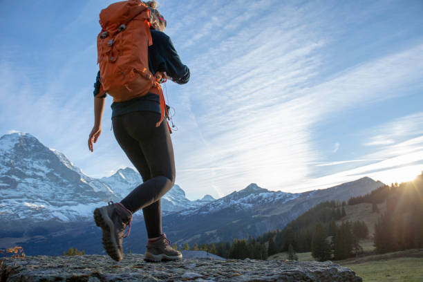 istock Female hiker relaxes on mountain ridge at sunrise 1285790152