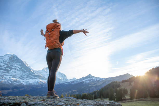 istock Female hiker relaxes on mountain ridge at sunrise 1285790161