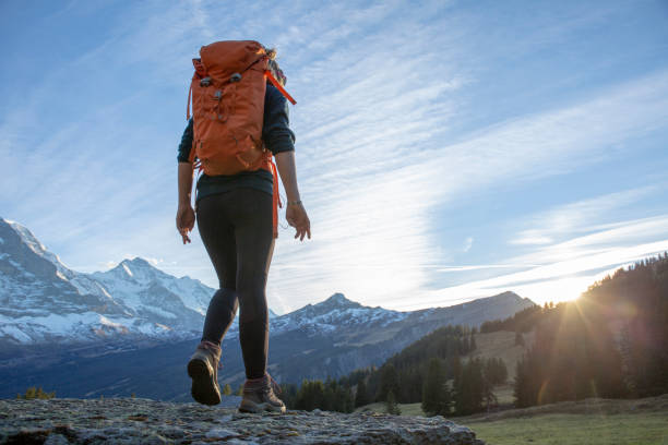 istock Female hiker relaxes on mountain ridge at sunrise 1285790166