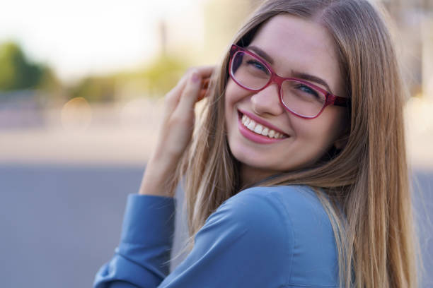 istock Portrait smiling woman in eyewear 1285791390