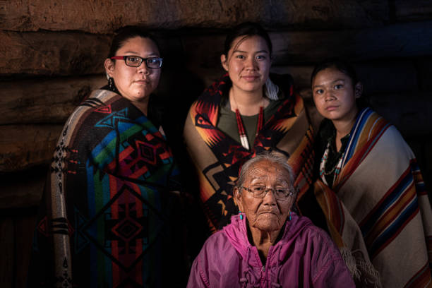 a fine art portrait of a native american grandmother and her three granddaughters in their family hogan - india traditional culture indigenous culture women imagens e fotografias de stock