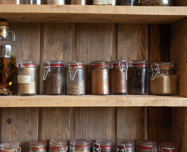 Bottles with spices and seasonings in wooden rack. Various different organic herbs for in the kitchen vintage look Bottles with spices and seasonings in wooden rack. Various different organic herbs for in the kitchen vintage look Many spice rack stock pictures, royalty-free photos & images