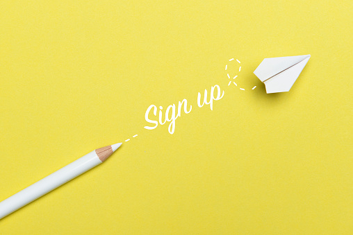White pencil with Sign Up text and a white paper plane on yellow background.