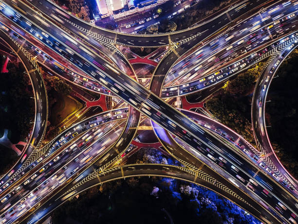 drone point view of overpass and city traffic at night - city vitality speed highway imagens e fotografias de stock
