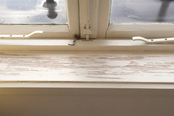 istock Old wooden window sill with cracked peeling paint and durt, needs renovation and repaired, replaced 1285794101