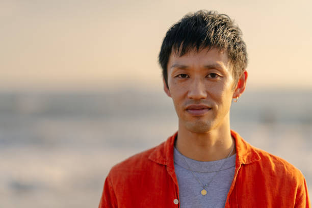 istock Portrait of handsome man at beach 1285794448