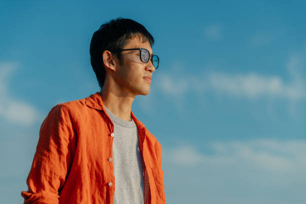 istock Portrait of handsome man at beach 1285794515