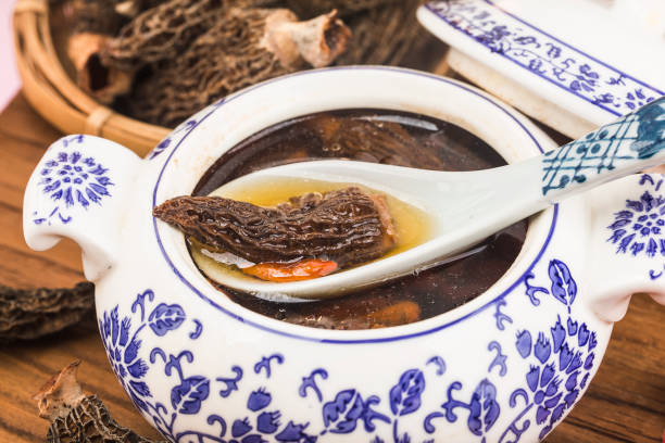 A bowl of Morchella and black chicken soup A bowl of Morchella and black chicken soup squab pigeon meat photos stock pictures, royalty-free photos & images