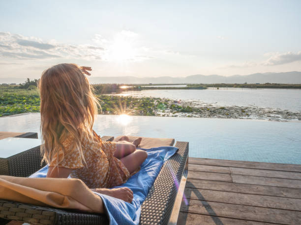 istock Woman relaxing by the poolside 1285798151