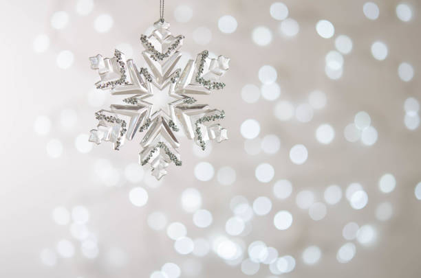 istock Transparent toy snowflake. Bokeh. Silver Christmas lights. 1285798168