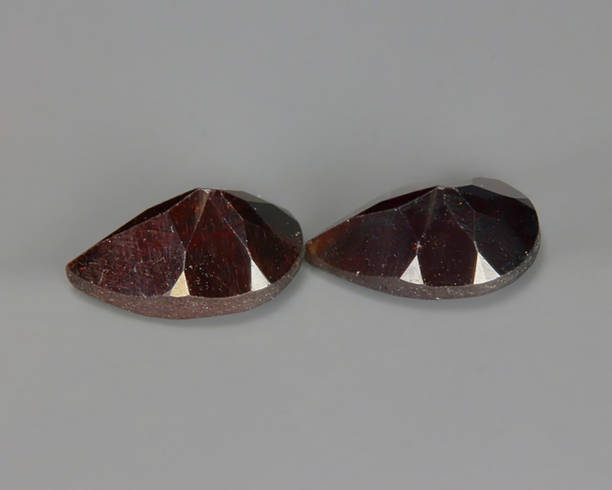 istock Natural almandine on a gray background. Natural stone garnet 1285798356