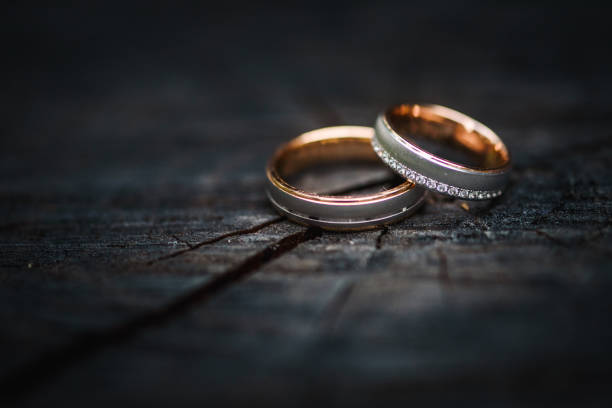 istock Wedding ring on a piece of wood 1285799753