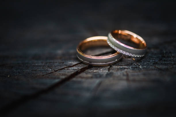 Wedding ring on a piece of wood stock photo
