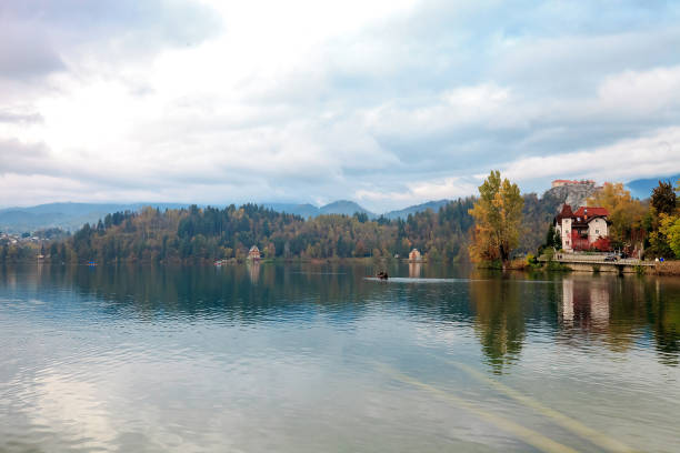 Autumn landscape with lake Bled by cloudy sky in Slovenia