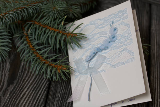 istock Greeting card among the fir branches. On black pine boards. 1285803937