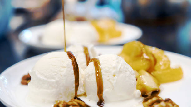 istock Vanilla icecream with fried orange and apple poured with delicious narsharab sauce. Walnut. Close up 1285805325
