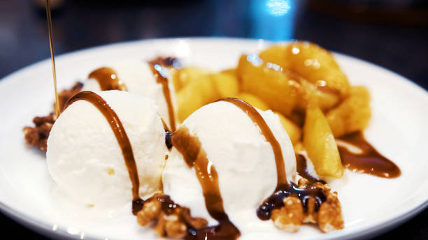 istock Vanilla icecream with fried orange and apple poured with delicious narsharab sauce. Walnut. Close up 1285805340