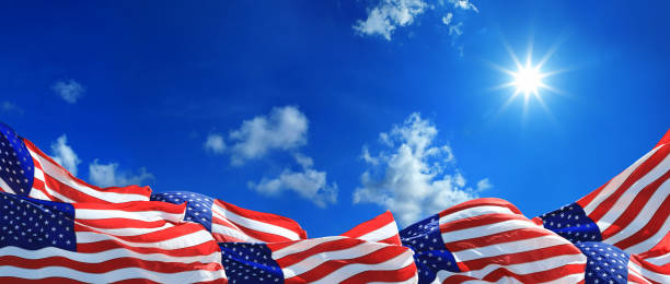 istock Group of waving American flags over sunny blue sky. 1285807396