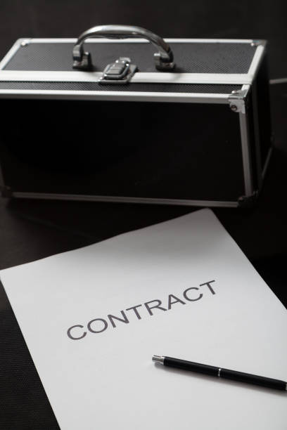 istock Contract and case for money close-up 1285808822