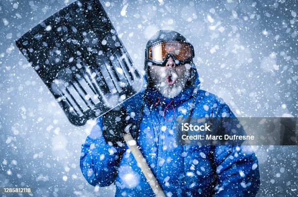 Man With Goggles And Shovel During Snowstorm Stock Photo - Download Image Now - Humor, Winter, Blizzard