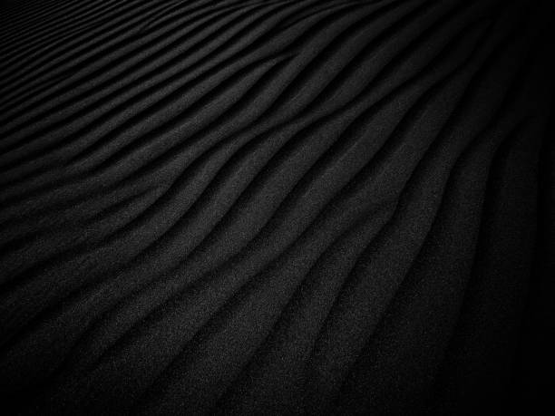 Black Sand beach macro photography. Texture of black volcanic sand for background. Close-up macro view of volcanic sand surface black color. Black and white poster texture sand in the desert. Black and White Sand beach macro photography. Texture of black and whote sand for background. Close-up macro view of volcanic sand surface black and white color. Black and white poster texture sand in the desert.Black Sand beach macro photography. Texture of black volcanic sand for background. Close-up macro view of volcanic sand surface black color. Black and white poster texture sand in the desert. black sand stock pictures, royalty-free photos & images