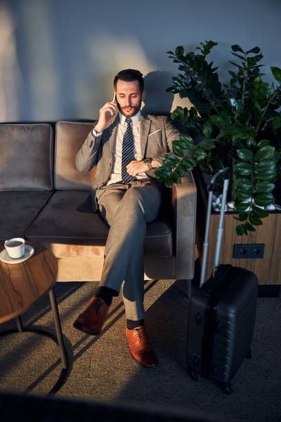 istock Business professional checking the time while speaking on a phone 1285812452