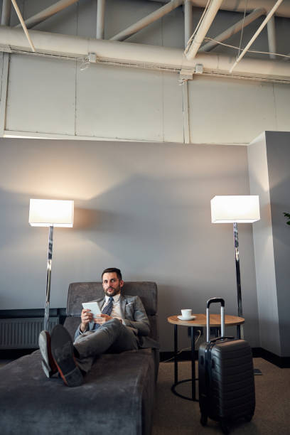 istock Businessman reclining on a bed with a tablet 1285812468