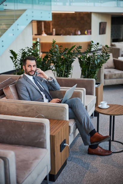 istock Businessman making a phone call in a waiting room 1285812511