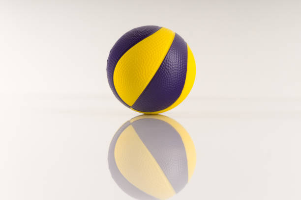 istock Basketball ball with yellow and purple spots on a white background. 1285814101