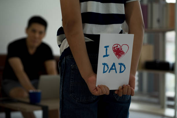 istock Asiab boy son playing with businessman using computer laptop of work from home 1285815100