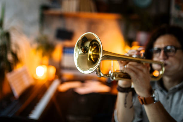 istock Musician with dreadlocks performing jazz song on trumpet 1285815509