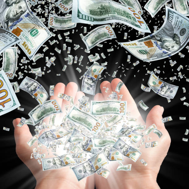 istock Large group of money falling into palms of hands 1285816313