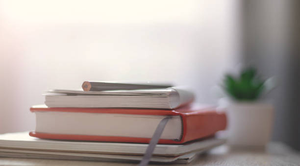 istock Workplace. Books, notebooks on the table opposite the window. Work at home 1285816343