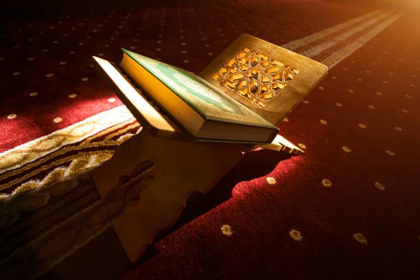 Quran in a mosque Quran - holy book of Muslims, scene in a mosque koran photos stock pictures, royalty-free photos & images