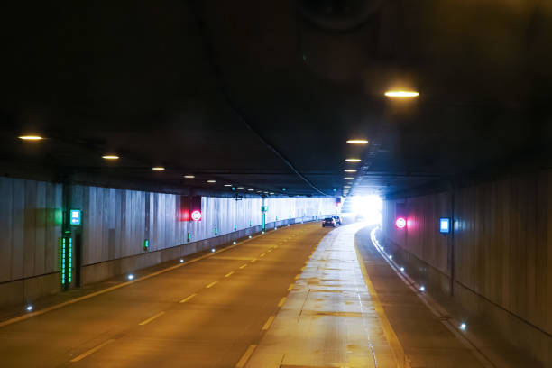 istock Car tunnel, traffic on the highway. Car drives through the tunnel. Emergency exit from the tunnel, emergency telephone 1285817961