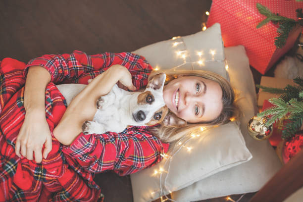 istock Happy woman on Christmas tree background 1285818034
