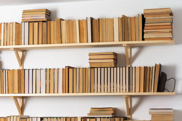 istock Bookshelves with hardback overturned books 1285820292
