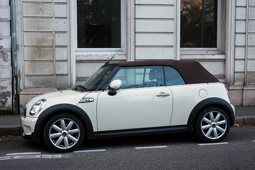 Mulhouse - France - 15 November 2020 - Profile view of beige mini cooper S convertible parked in the street