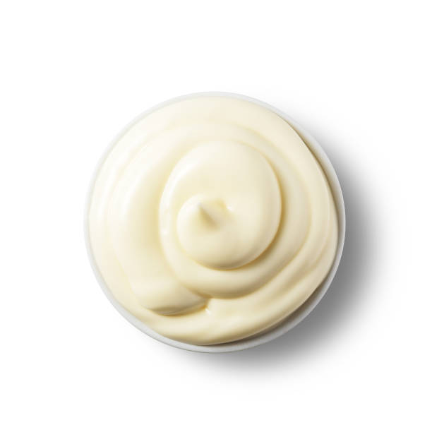istock Fresh mayonnaise in a bowl on a white isolated background. Top view. 1285823368