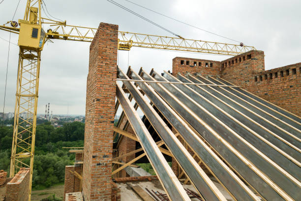 istock Unfinished brick apartment building with wooden roof structure under construction. 1285823877