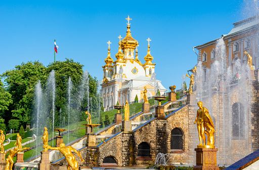 St. Petersburg, Russia - June 2019: Grand Cascade of fountains and East Chapel of Peterhof Palace