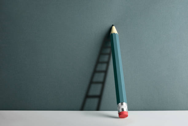 istock A pencil leaning against the wall. Ladder shade reflect on the wall. 1285825913