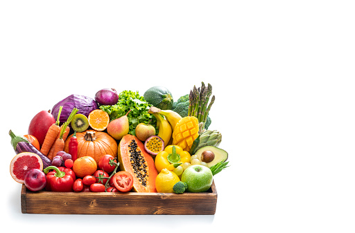 Assorted vegetables and fruits in wooden crate box isolated on white background
