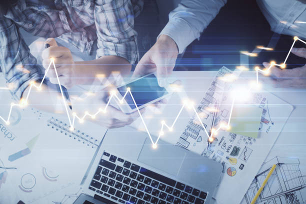 istock Double exposure of forex graph drawing and man and woman working together holding and using a mobile device. Trade concept. 1285827083