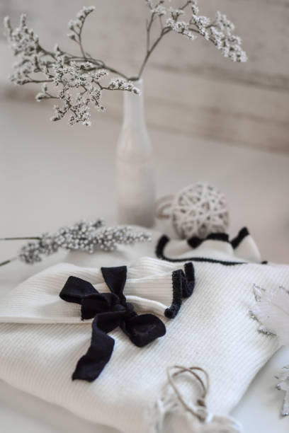 istock White sweater with black bow and home winter holiday decoration 1285827410