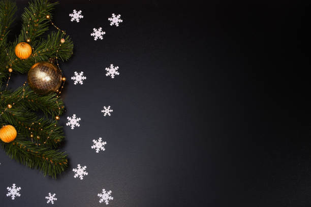 istock Christmas composition. Snowflakes, spruce branches, Christmas toys on a black background 1285828601
